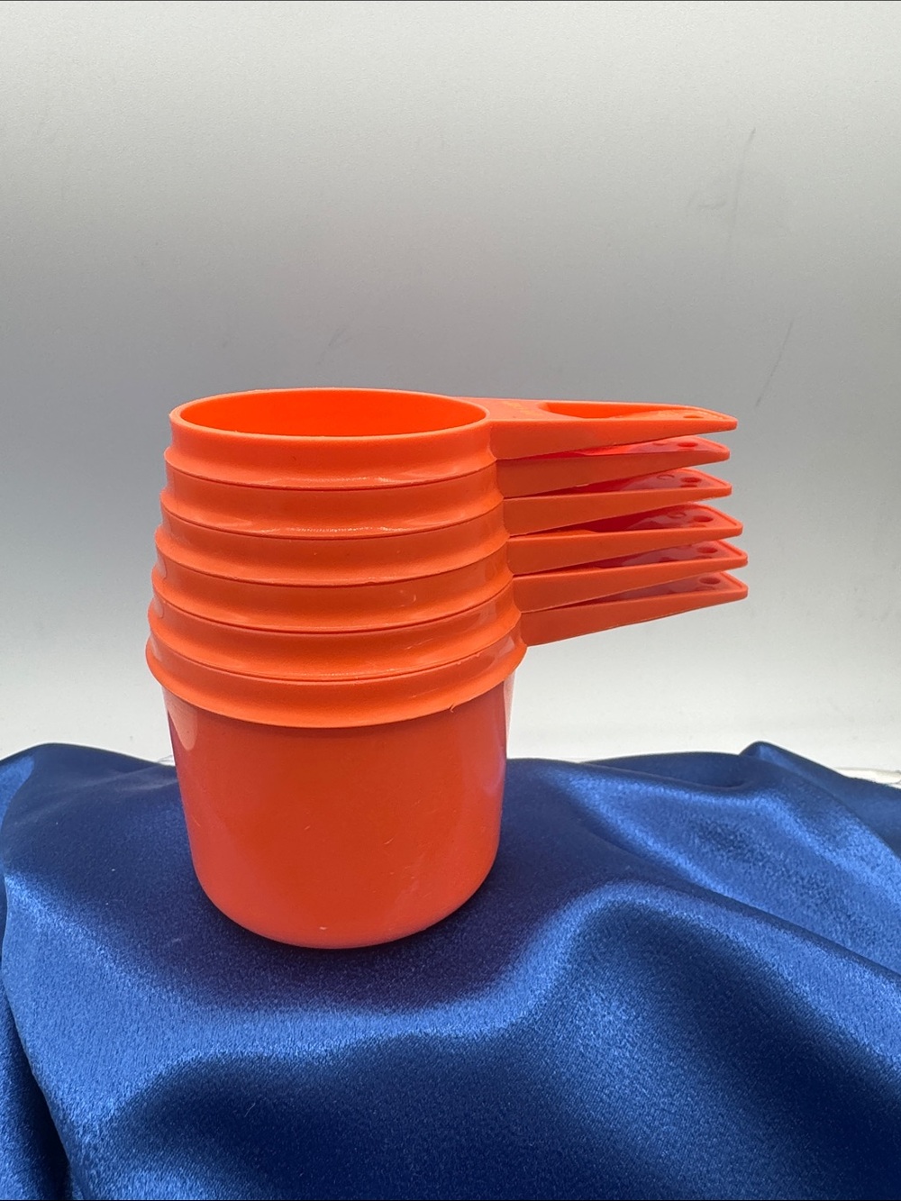 Tupperware measuring cups from 1/4 to 1 cup capacities, Harvest Orange.